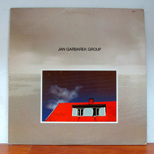 Jan Garbarek Group – Photo With Blue Sky, White Cloud, Wires, Windows And A Red Roof